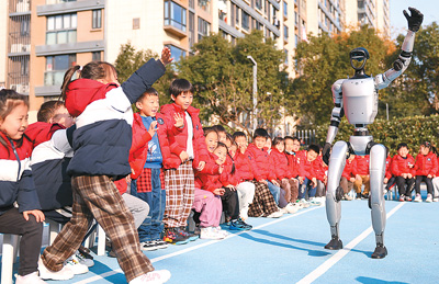  2025年1月2日，浙江省宁波市江北区甬港幼儿园的孩子们在科普活动现场与机器人互动，感受先进科技成果、体验科学魅力。   新华社记者 江 汉摄