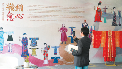 参观者在中国服饰美学展“衣脉相承，织锦愈心——中华文明中的疗愈密码”上欣赏、拍摄展品。
