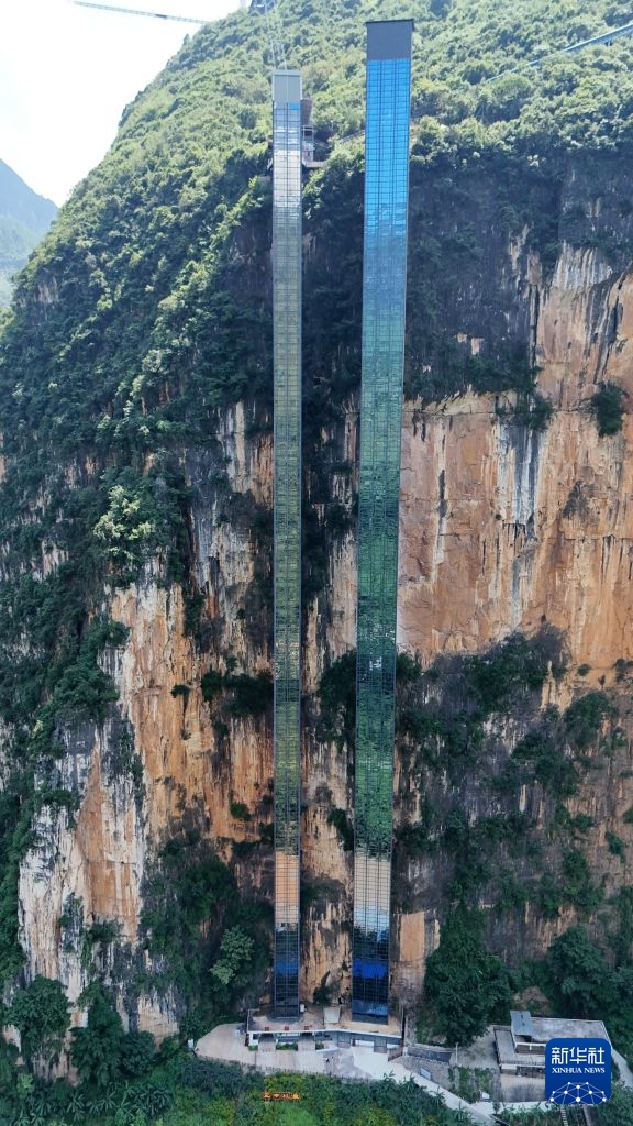 7月31日在云南省宣威市尼珠河大峡谷景区拍摄的“扶摇梯”（右）和“青云梯”两部悬崖电梯（无人机照片）。新华社发