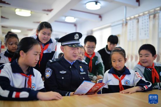 4月13日，在山東省青島市市北區重慶路第三小學開展的國家安全教育主題活動上，邊檢站民警為學生講解國家安全相關知識。新華社發（王海濱攝）