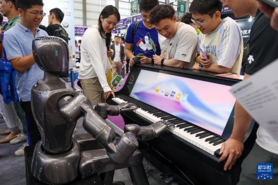 4月24日，參觀者觀看人形機器人彈鋼琴。新華社記者 毛思倩 攝