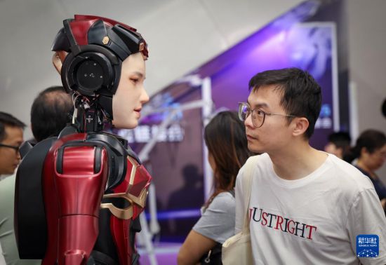 4月24日，參觀者在數字華夏展台查看一款具有情感交互能力的人形機器人。 新華社記者 毛思倩 攝