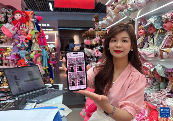 5月21日，孙丽娟在商铺内展示相关AI应用中的多语种视频。新华社发（唐艳清摄）