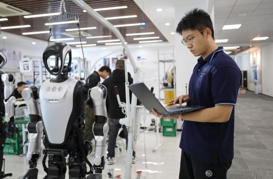 2025年10月24日，机器人应用开发工程师张鸿伟在电脑上查看人形机器人的测试运行数据。新华社记者 杜潇逸 摄